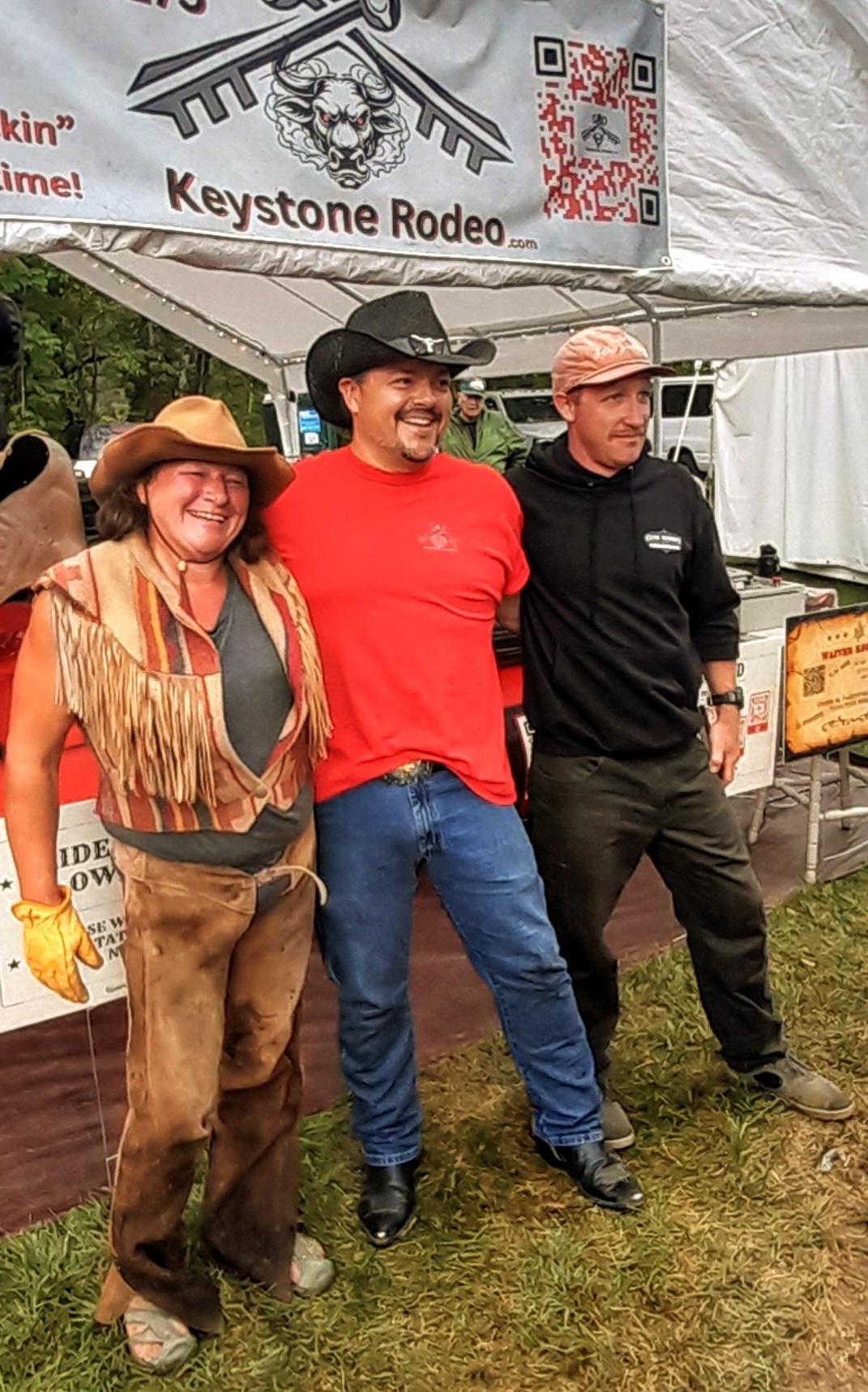 Keystone Rodeo crew posing together under the event tent