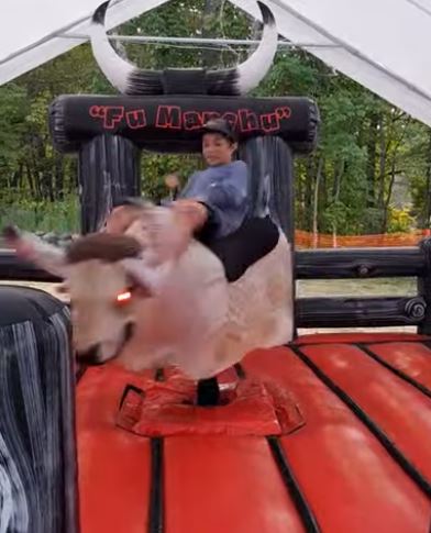Woman riding Fu Manchu the mechanical bull