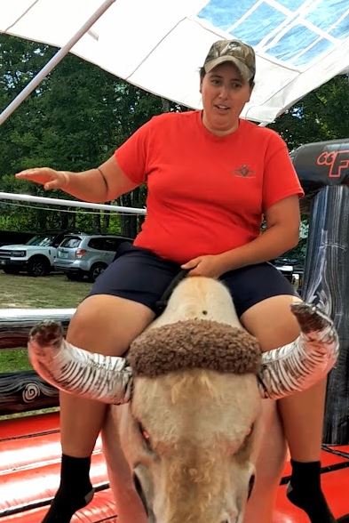 Woman riding Fu Manchu the mechanical bull